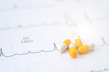 Capsules on electrocardiograph with healthy and medical concept