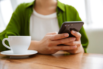 Smiling asian woman using mobile phone
