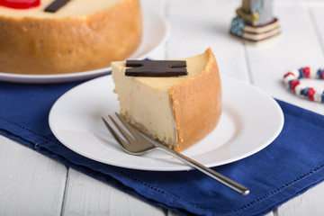 Delicious slice of new york cheesecake with word  on white background. Sweet and tasty food, coffee break concept. Classic american dessert.