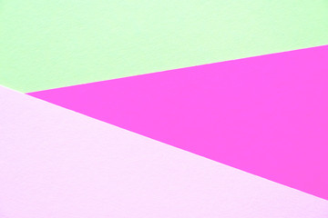 Lilac, soft pastel green and light pink colored textured paper for the background. Geometric empty paper background of three tones for copy space.