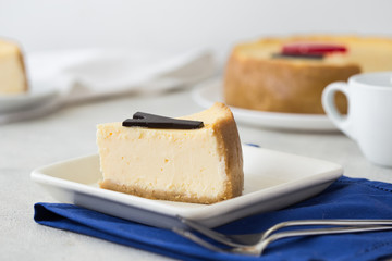Delicious slice of new york cheesecake with word  on white background. Sweet and tasty food, coffee break concept. Classic american dessert.