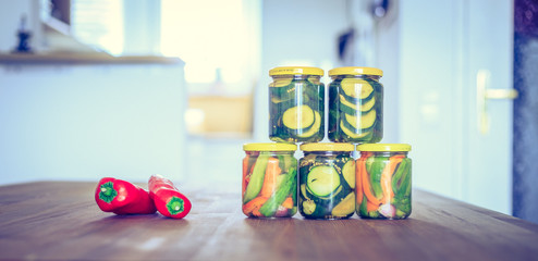 Variety of tasty vegetables in preserving glasses. Conservation of food.