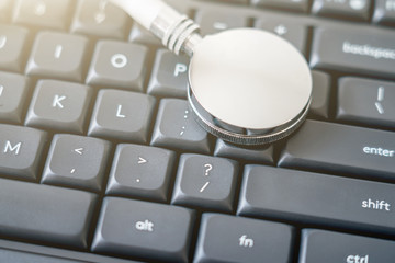 Stethoscope on black computer keyboard with network information leak concept