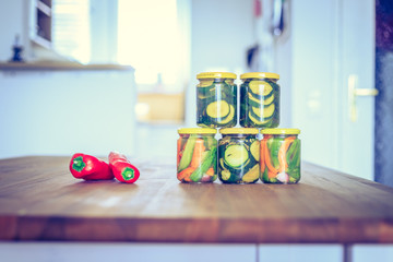 Variety of tasty vegetables in preserving glasses. Conservation of food.
