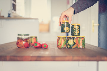 Variety of tasty vegetables in preserving glasses. Conservation of food.