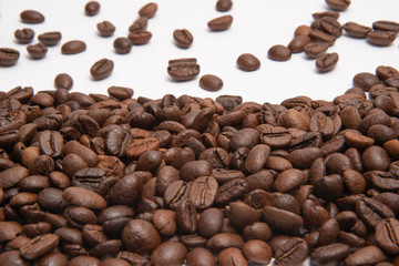 Freshly roasted coffee beans sprinkled with beans on burlap with copy space for text