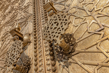 Fototapeta na wymiar Golden door detail with door handle of the royal palace in Fez, Morocco.