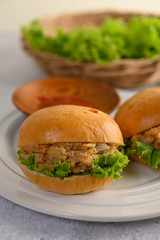 Two hamburgers placed in white dish beautifully