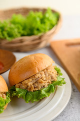 Two hamburgers placed in white dish beautifully