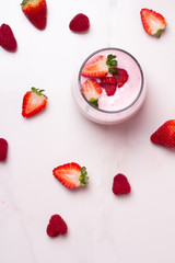glass with yogurt and fresh raspberries and strawberries