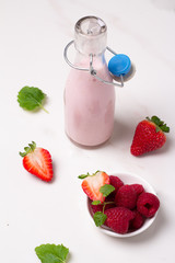 yogurt with fresh strawberries on white