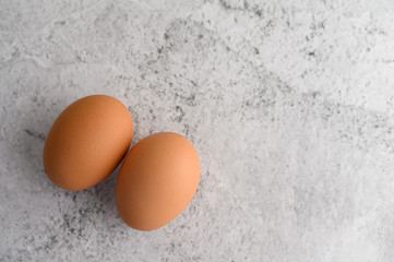 Two organic brown eggs on the floor