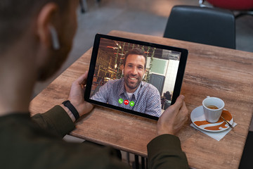 Man doing video call on tablet - obrazy, fototapety, plakaty