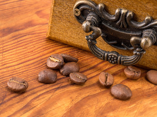 roasted coffee beans on wooden background.