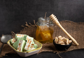 Homemade pistachio nougat on a dark rustic background