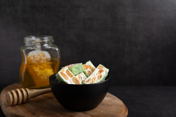 Homemade pistachio nougat on a dark rustic background