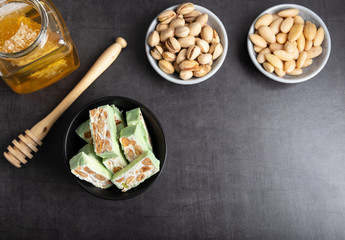 Homemade pistachio nougat on a dark rustic background