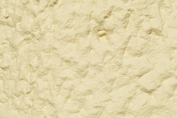 Gelbliche grobe Steintextur, Hausmauer, Schatten