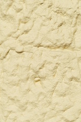 Gelbliche grobe Steintextur, Hausmauer, Schatten