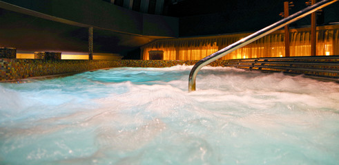 Big whirlpool or thalasso and thalassotherapy pool inside spa and wellness thermal suite on luxury cruise ship liner or cruiseship - obrazy, fototapety, plakaty
