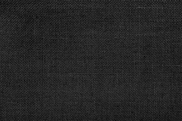 Tuinposter Close-up texture of natural weave cloth in dark and black color. Fabric texture of natural cotton or linen textile material. Black fabric background. © Papin_Lab
