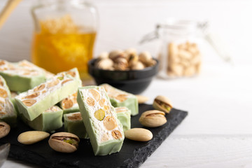 Homemade organic pistachio nougat on a white background .