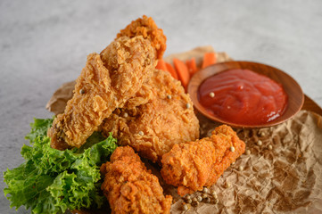 Crispy fried chicken on a plate with tomato sauce, Selective focus.