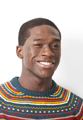 Obraz premium Happy young man in knitwear looking away over white background