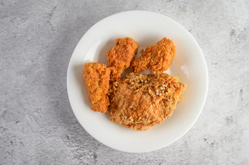 Crispy fried chicken sprinkled with pepper seeds, Top view.