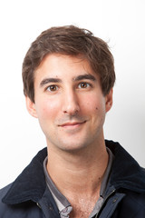 Fototapeta premium Portrait of handsome Middle Eastern young man smiling against white background