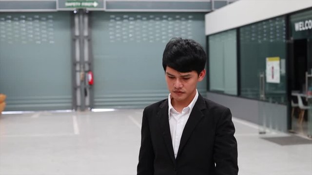 Asian man saleman walking to Checking Inspection period with car engine in showroom dealership.to automotive automobile or transport transportation video panning shot and people movement  4k clip