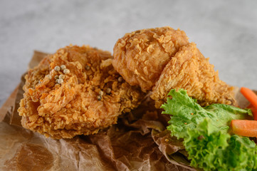 Crispy fried chicken on a wooden cutting board. Selective focus.