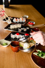 man pours tea from a teapot in a Japanese restaurant
