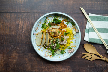Egg noodles topping minced pork and slic meat ball