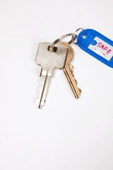 Keys with key ring tag on white background