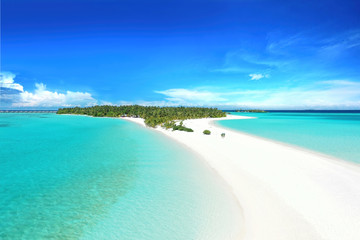 Summer background for vacation. Beautiful sandbar in turquoise ocean against blue sky with white...
