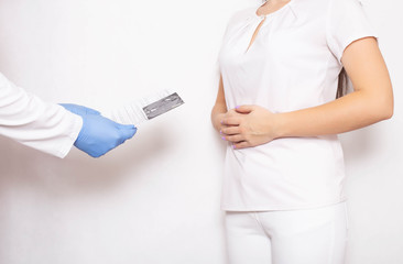 The doctor looks at the results of a study of gastric esophagogastroduodenoscopy for ulcers and cancerous tumors, background