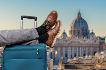 Tourist has legs on suitcase and relaxing in Rome.