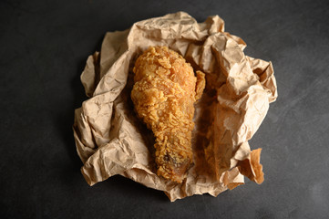 crispy fried chicken on a brown paper.