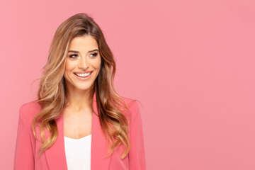 Happy smiling woman on pink background.