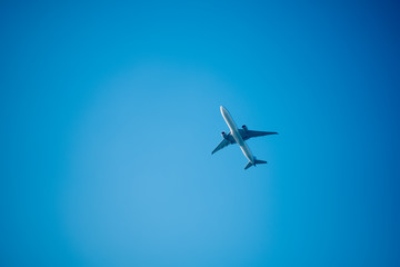 Commercial airline flying on blue sky