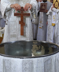 Orthodox Vira, Baptism and Jordan sanctified water. Orthodox priest zanur water with a water cross...