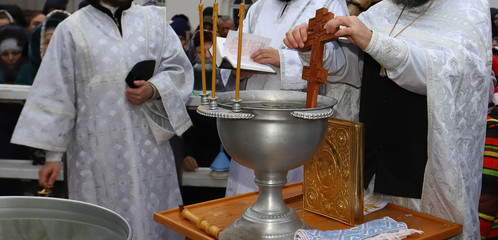 Orthodox Vira, Baptism and Jordan sanctified water. Orthodox priest zanur water with a water cross...