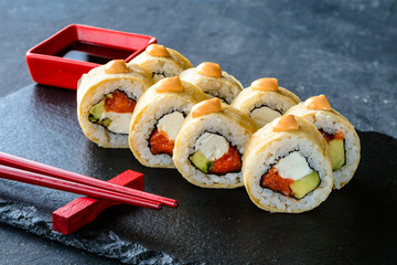 pancake sushi rolls on black