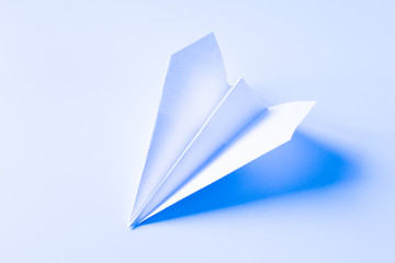 paper origami ship on blue background