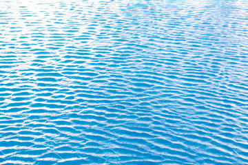 Water waves surface background. Aqua background texture. Abstract water ripples selective focus. Design element for banner and artwork