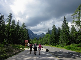 Strbske Pleso, High Tatras, Slovakia.  Tourists, people on the asphalt road in Strbske Pleso. Summer, cloudy day at High Tatras, Slovakia