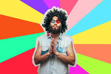 Friendly bearded young male hippie with curly hair in stylish sunglasses isolated on colorful...