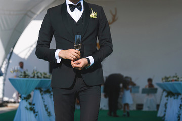 groom with glass of champagne