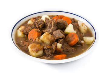 Irish beef stew with carrots and potatoes isolated on white background